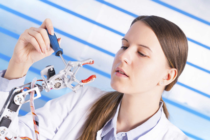 a woman using a tool to build  a mechanical object