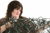 woman struggling with tangled christmas lights
