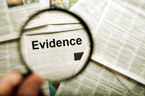 image of newspapers and magnifying glass with the word 'evidence' in the center