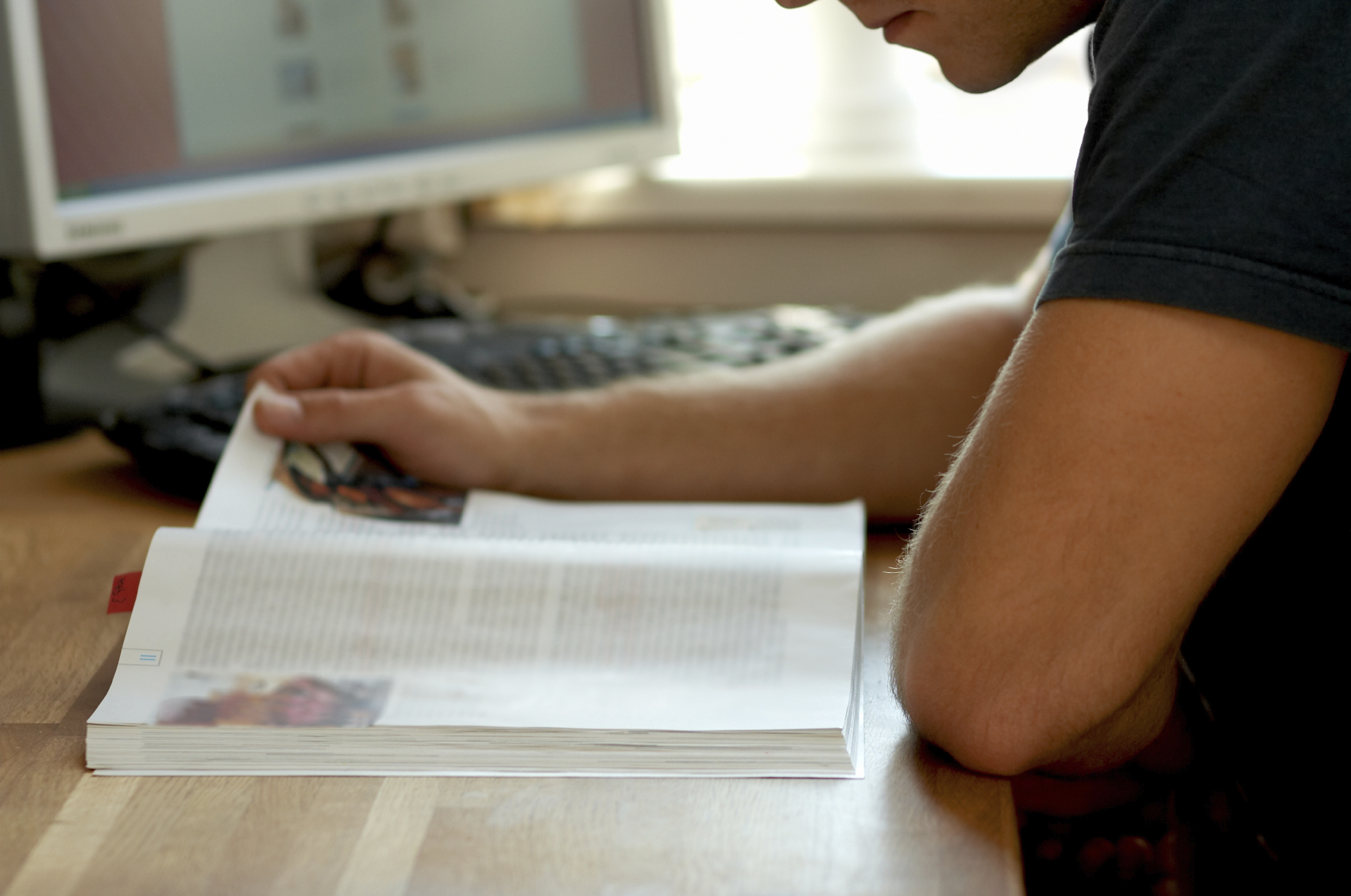 boy studying and writing at a computer 