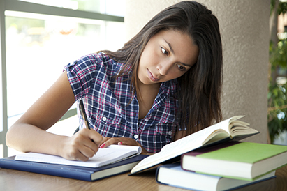 girl reading and taking notes